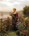 Mujer en un jardín paisana Daniel Ridgway Knight